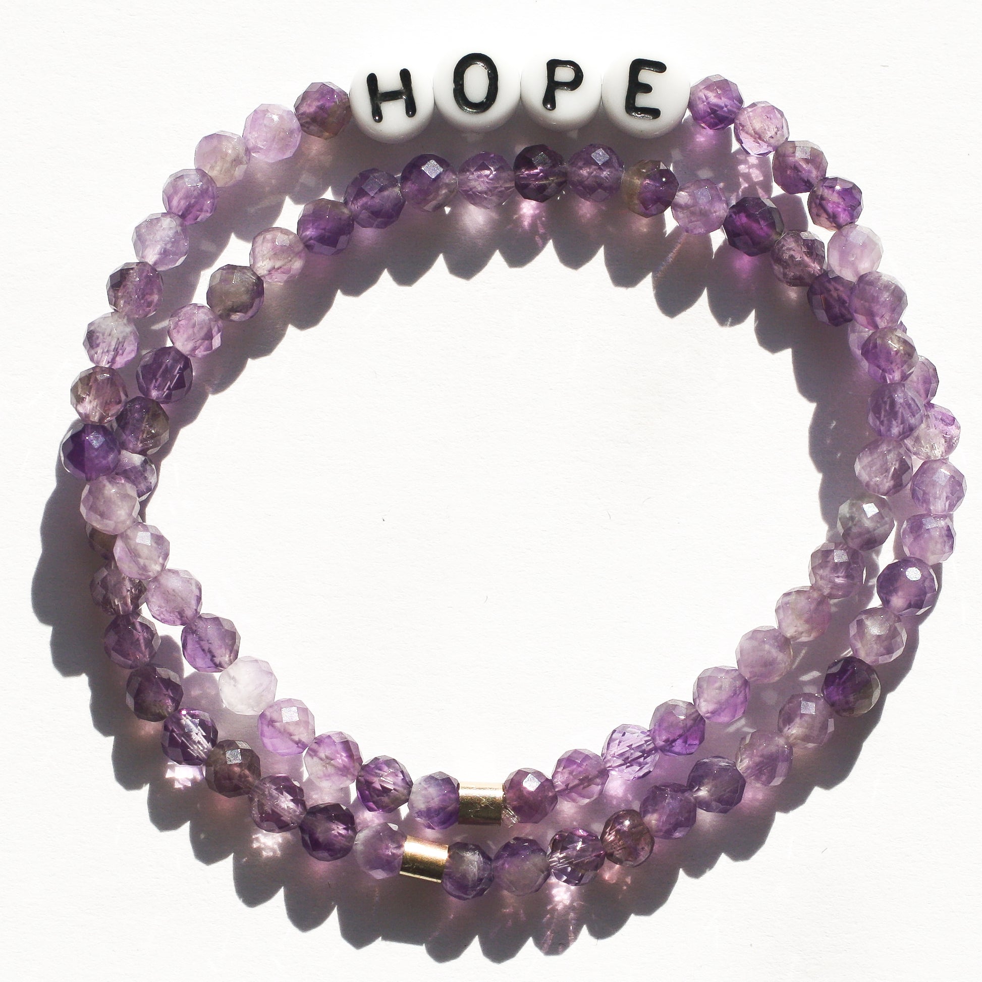 Stack of HOPE and stones-only amethyst bracelets