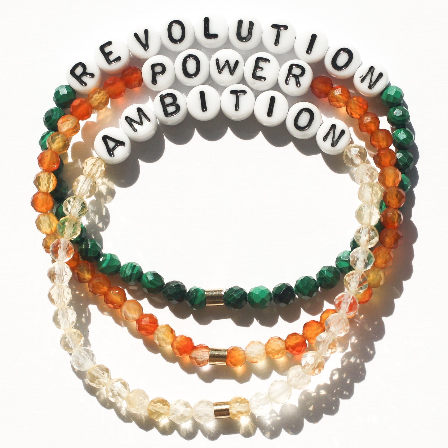REVOLUTION, POWER, and AMBITION bracelets