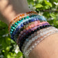 Stack of colorful crystal bracelets in the sunshine