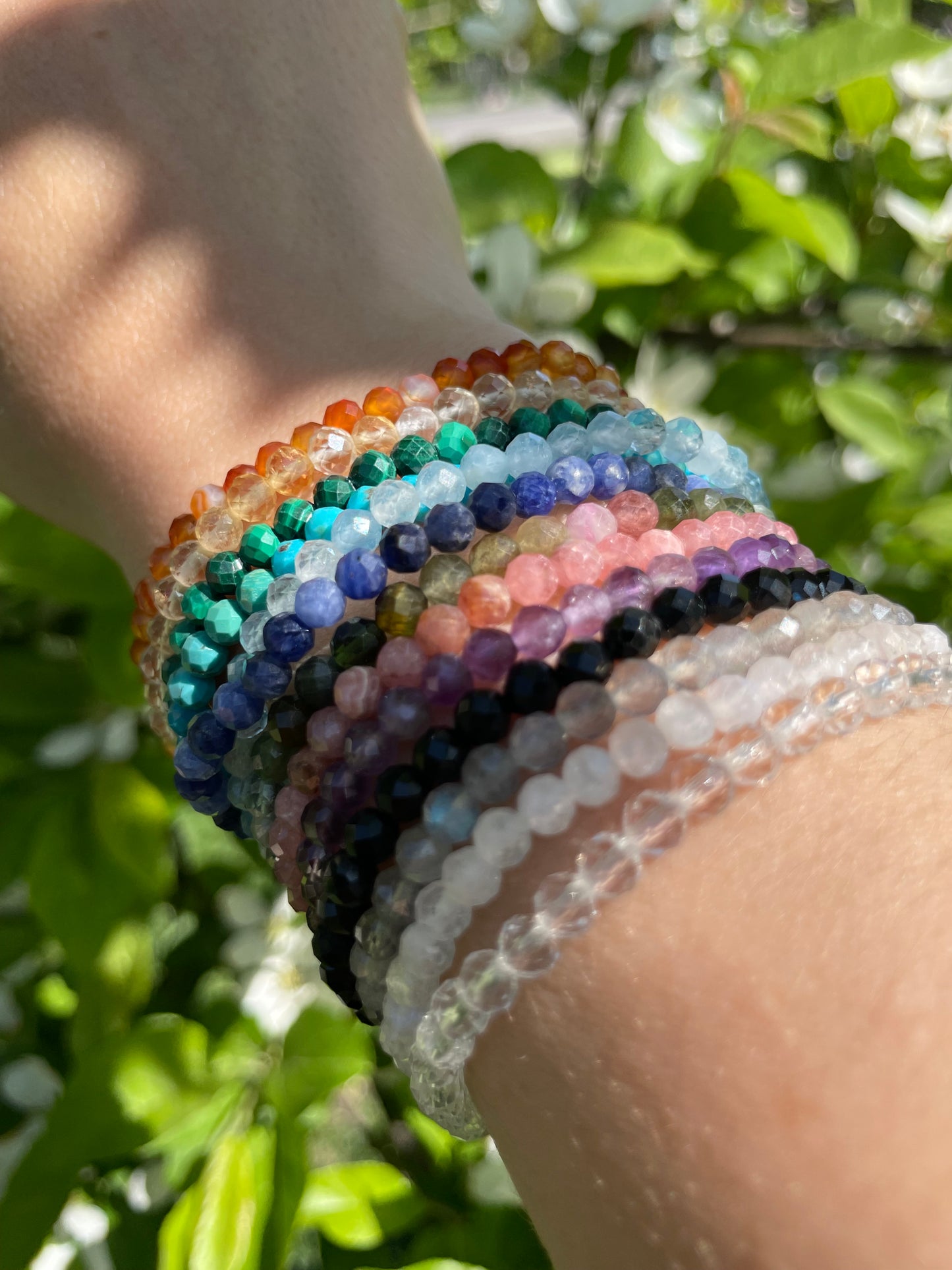 Stack of colorful crystal bracelets in the sunshine