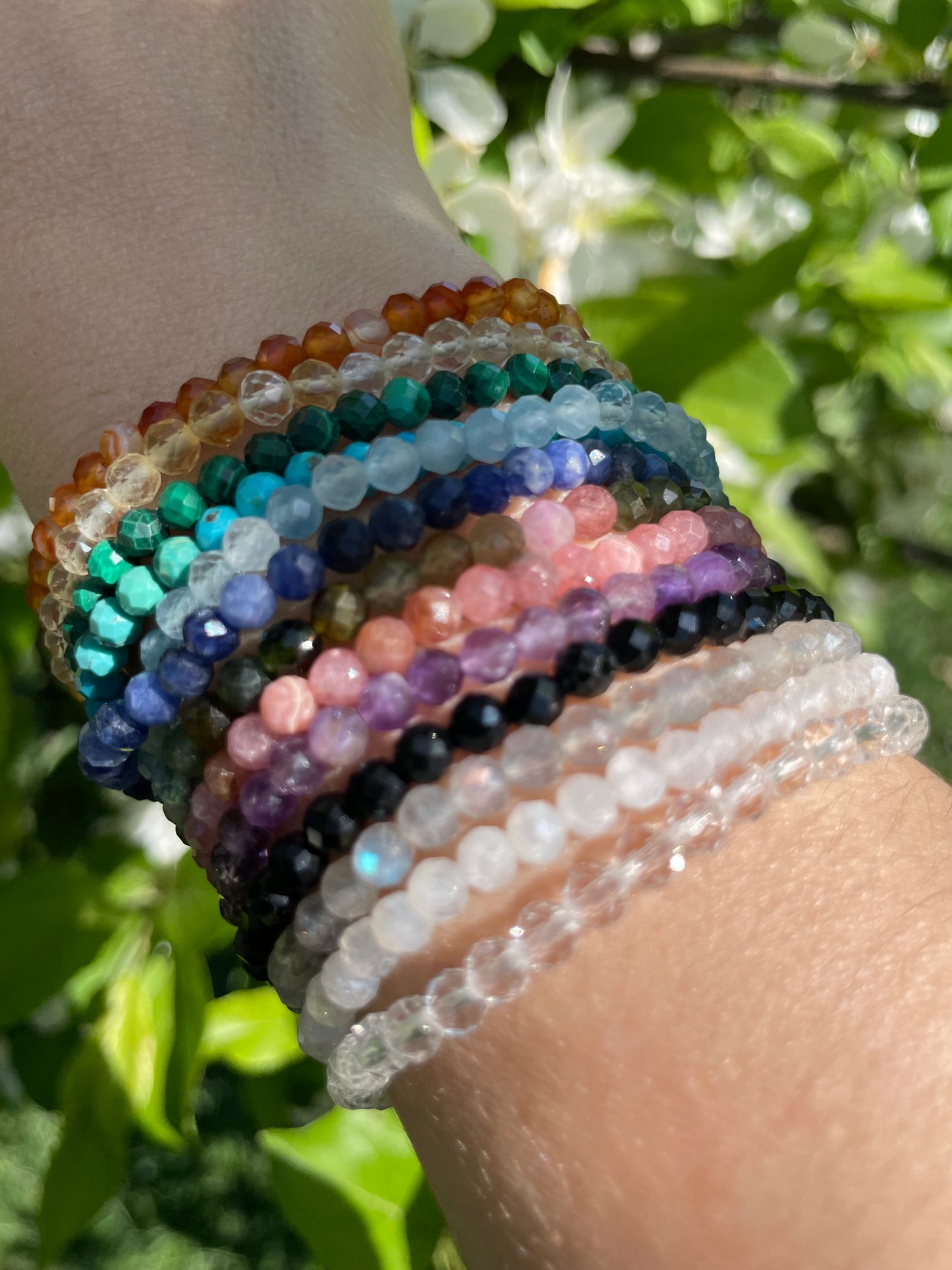 Stack of colorful crystal bracelets in the sunshine