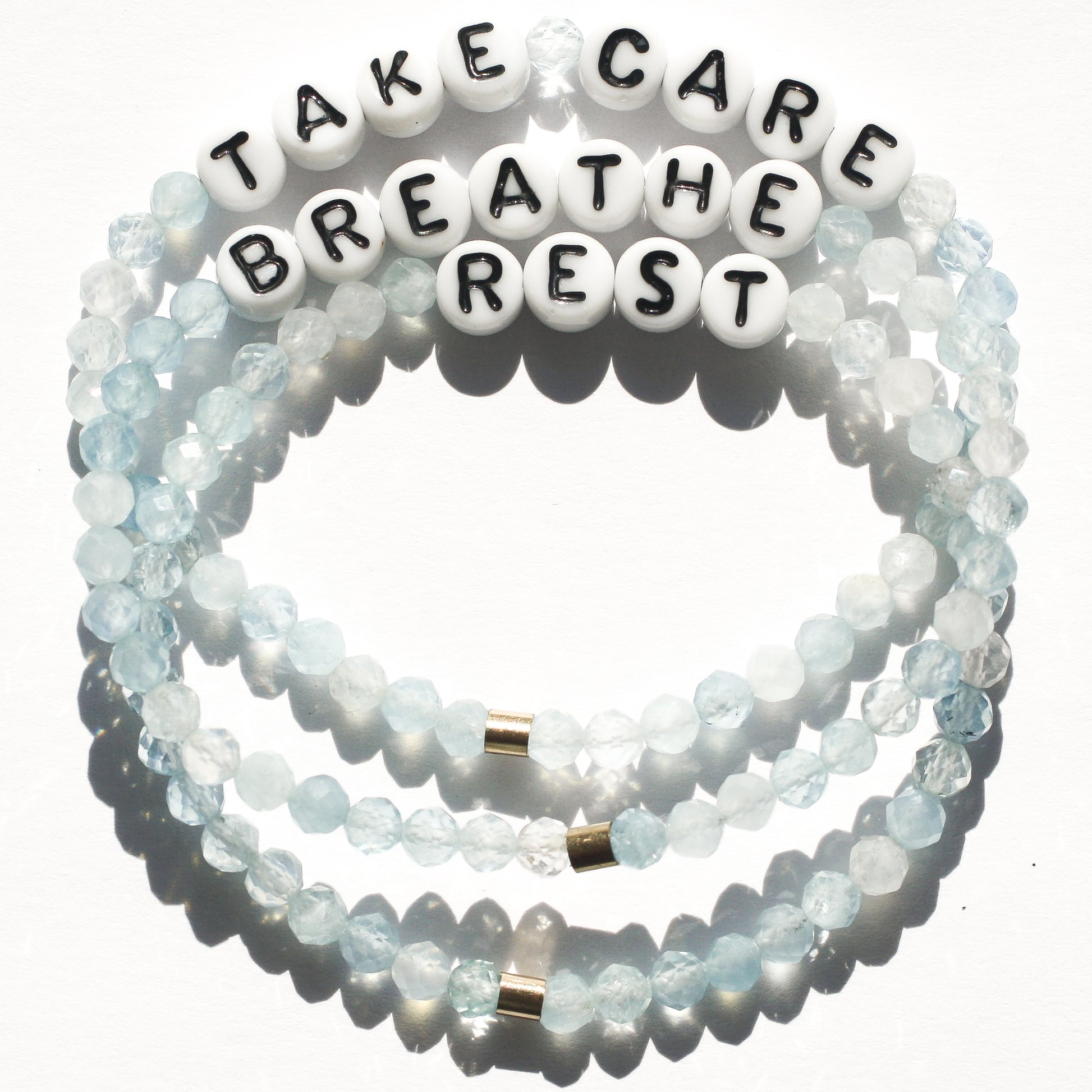 TAKE CARD, BREATHE, and REST bracelets in aquamarine